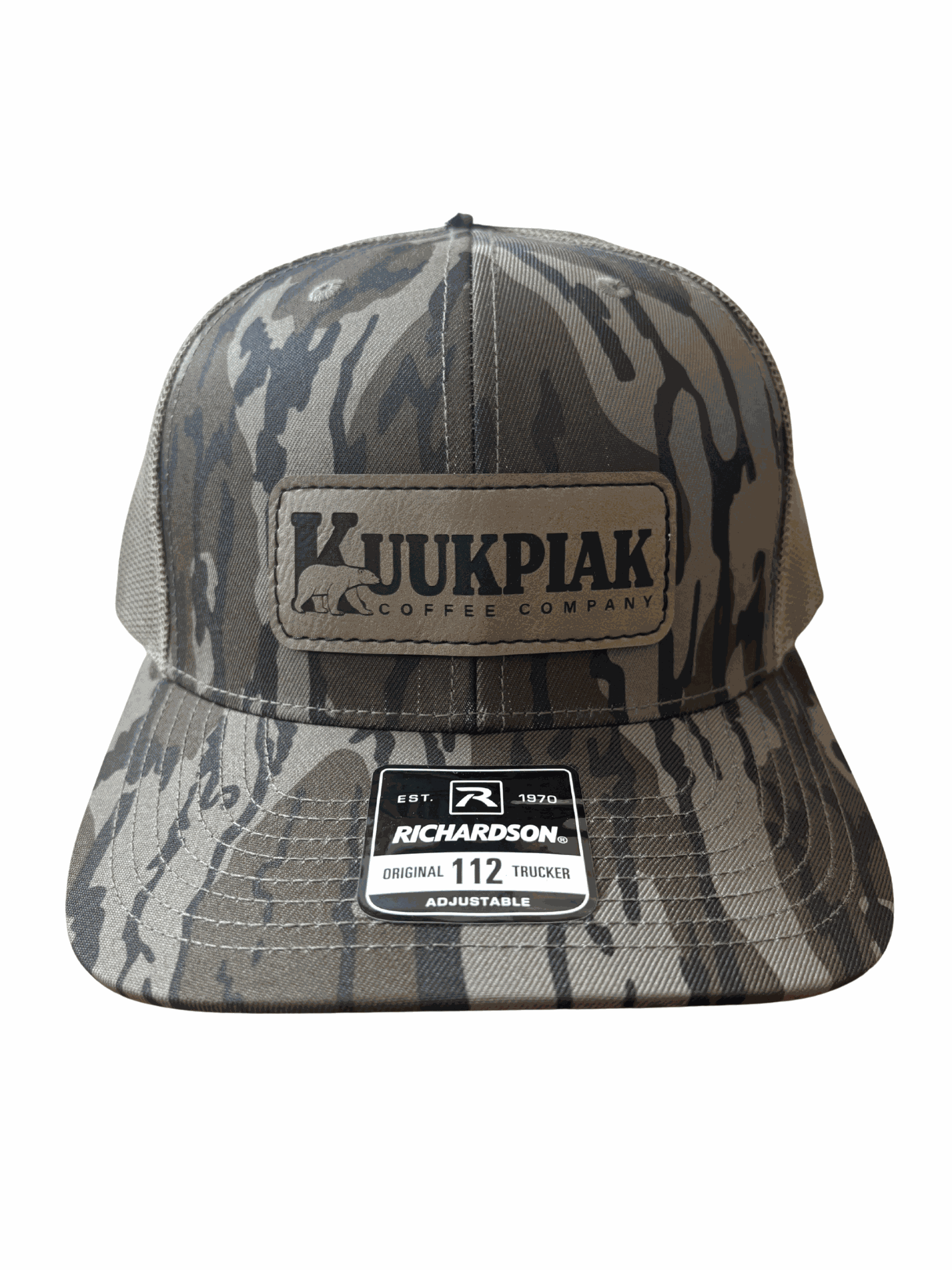 Mossy Oak Bottomland camo trucker hat with mesh back and Kuukpiak Coffee patch